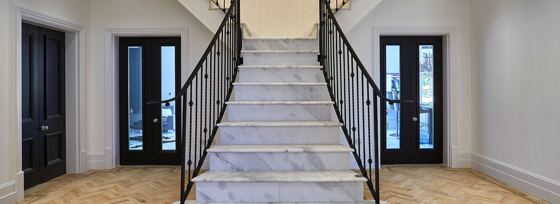 Marble staircase with oak parquet hallway flooring